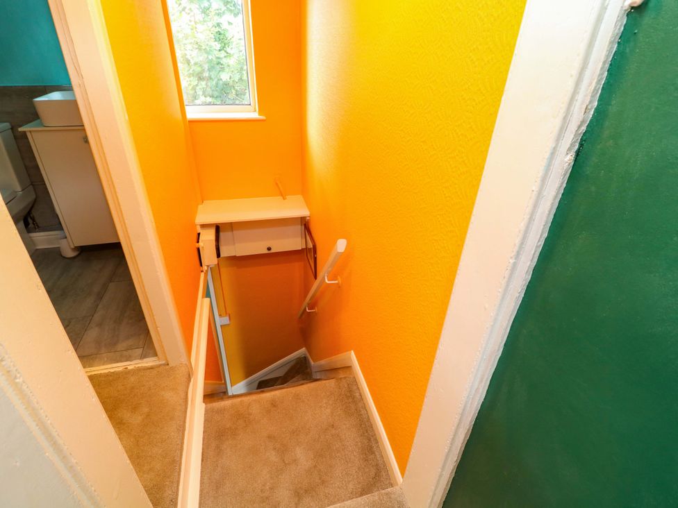 A staircase with a handrail in a hallway at 37 East Lane Mansfield