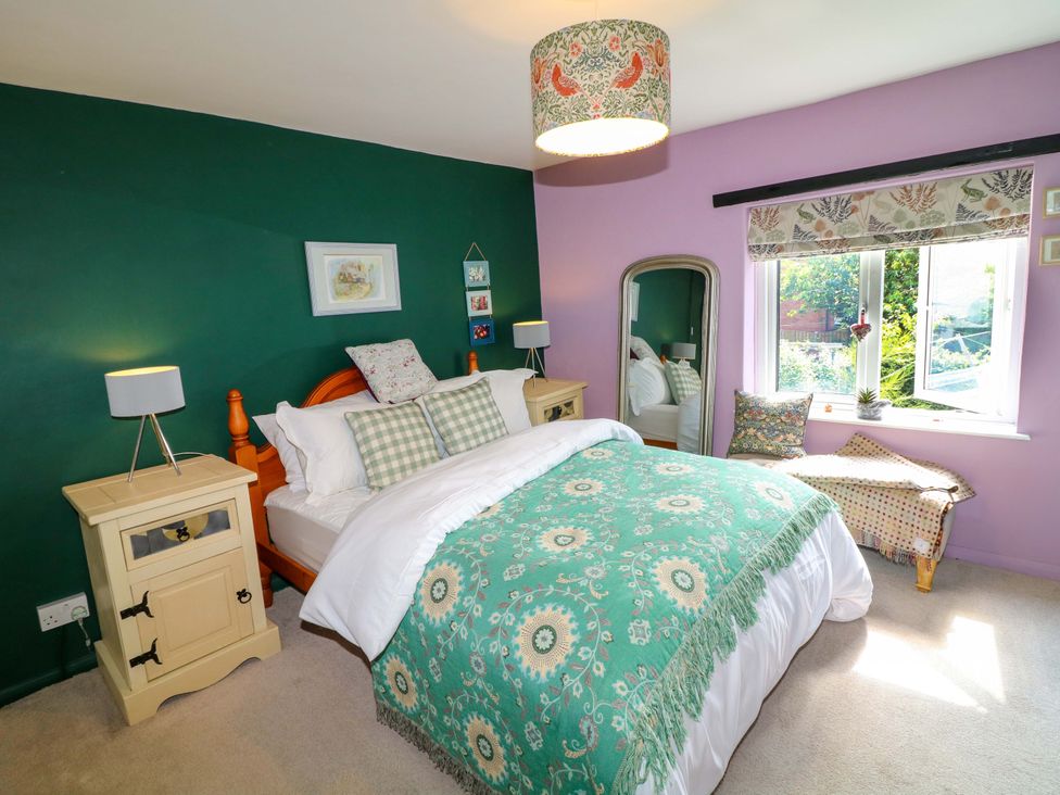 A bedroom with a bed and bedside table at 37 East Lane in Mansfield