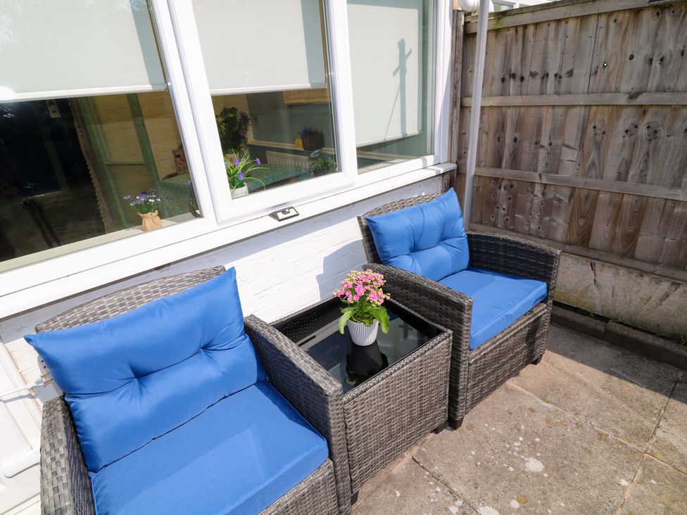 A garden area with two chairs and a table at 37 East Lane in Mansfield