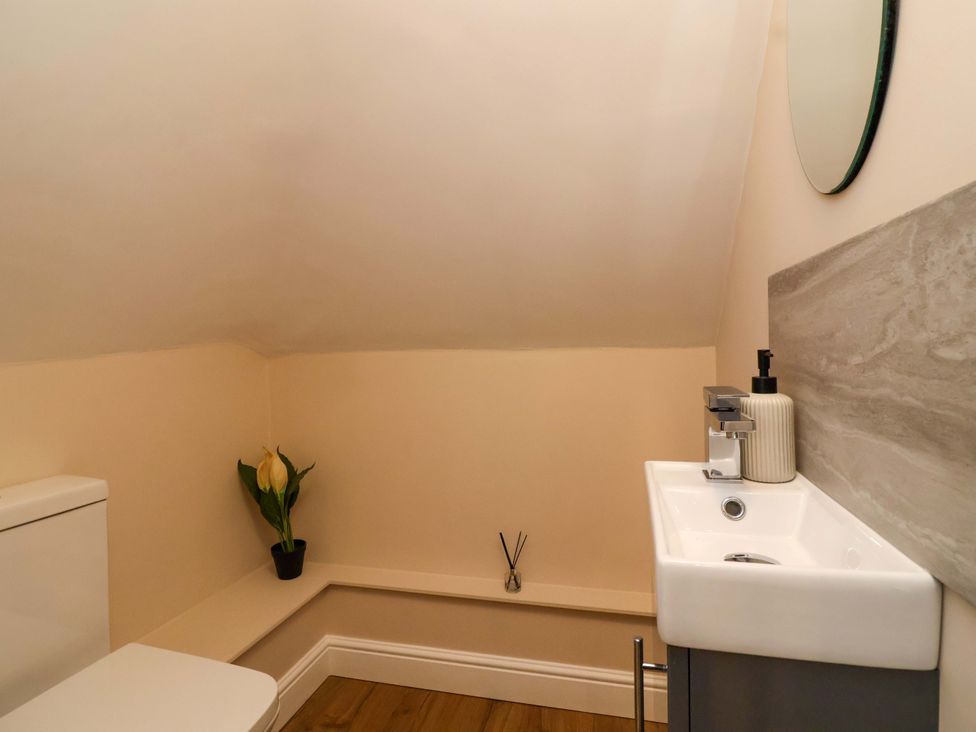 A bathroom with a toilet and sink at Poddington Cottage