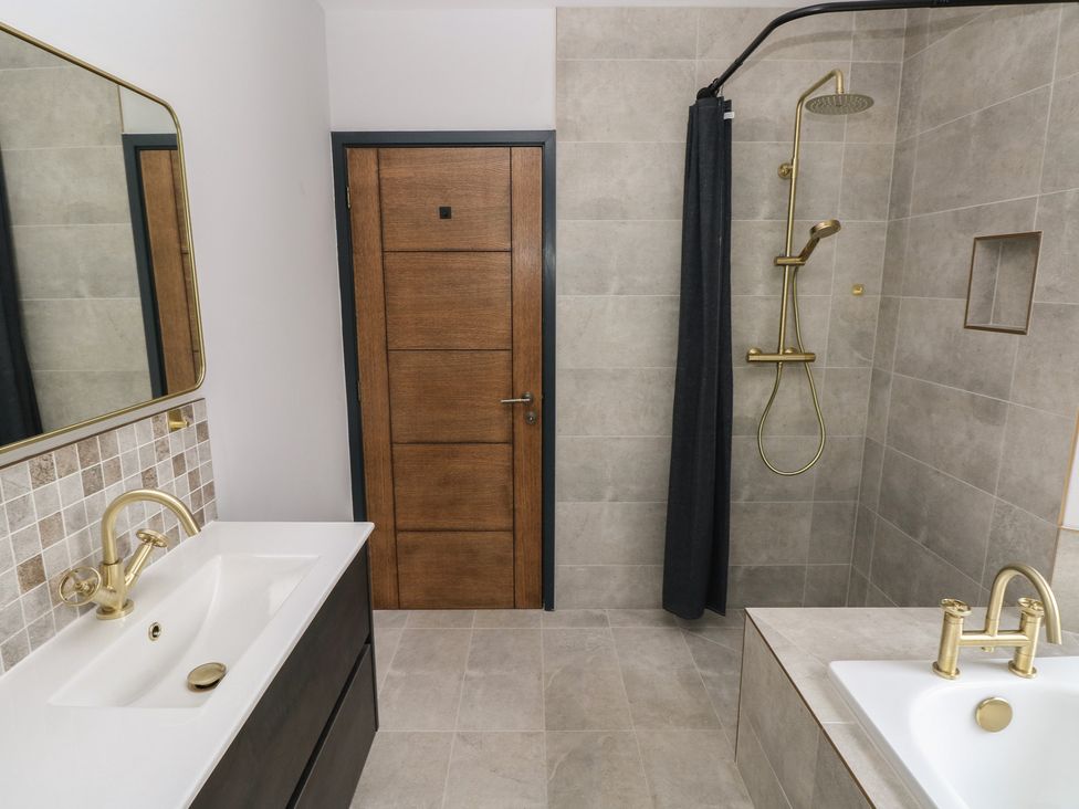 A bathroom with a sink and shower at 10 Brython Place in Tackley
