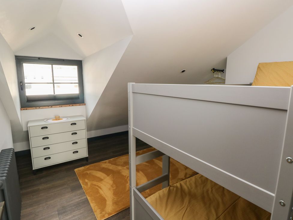 A bedroom with a bunk bed and dresser at 10 Brython Place in Tackley