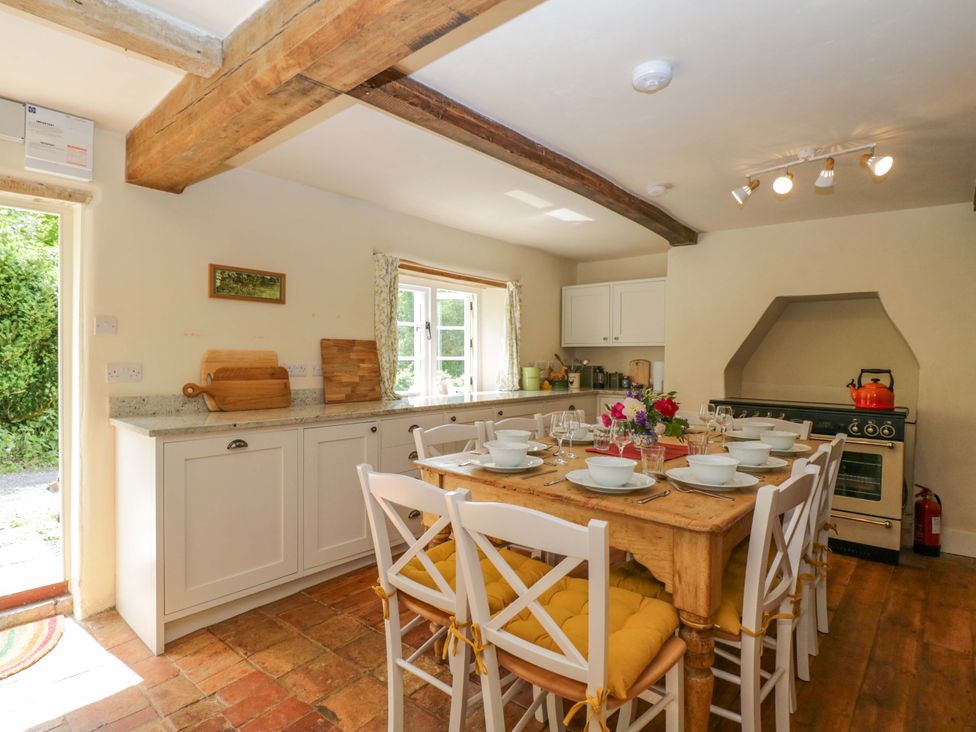 A kitchen with a dining table and chairs at Keepers Cottage in Devizes