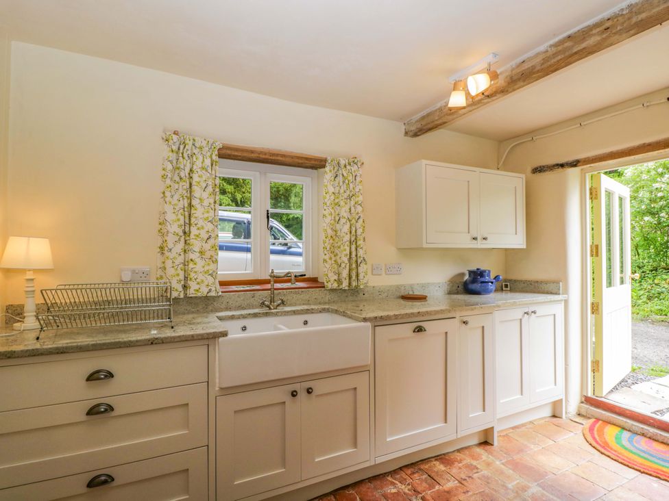 A kitchen with a sink and cabinets at Keepers Cottage in Devizes