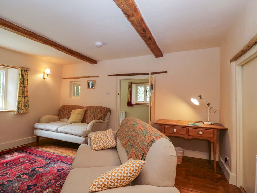A living room with a sofa and lamp at Keepers Cottage in Devizes