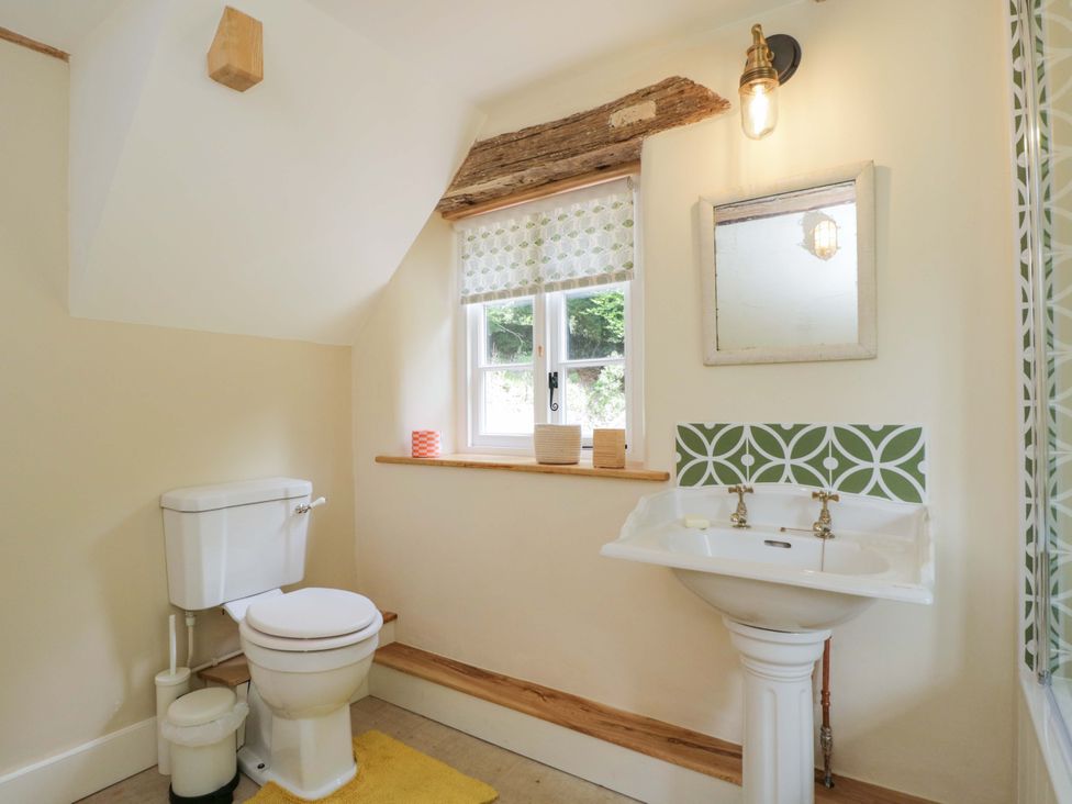 A bathroom with a toilet and sink at Keepers Cottage in Devizes