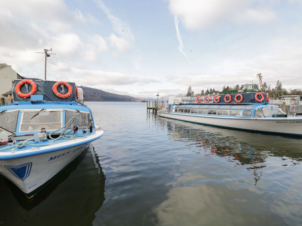 Two boats moored on a lake with hills in the background at Mere Brook Lodge in White Cross Bay