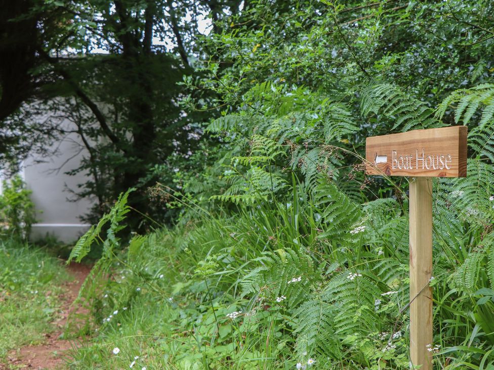 A path leading to a sign for The Boat House in Ashprington
