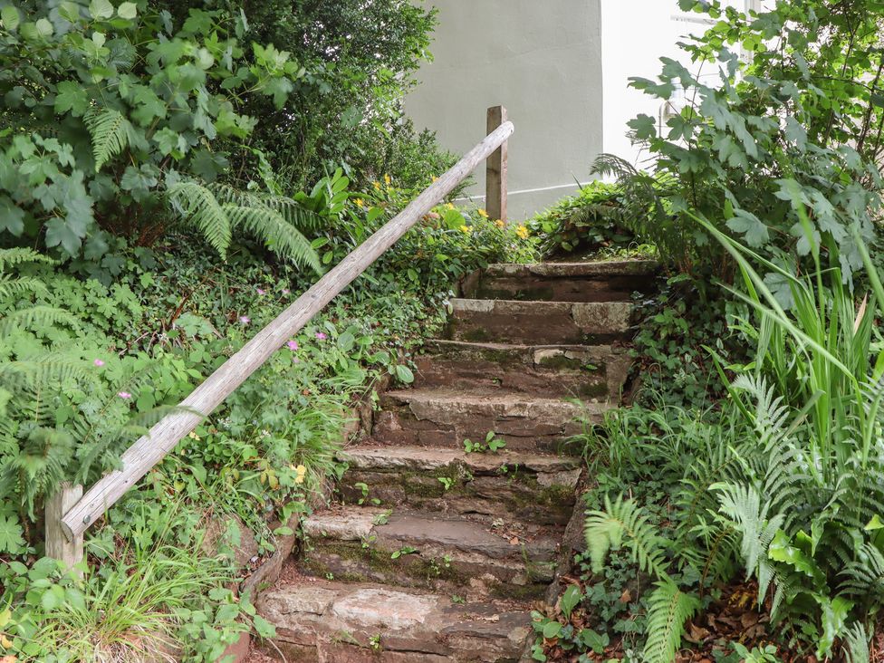 A pathway with stone steps and a handrail at The Boat House in Ashprington