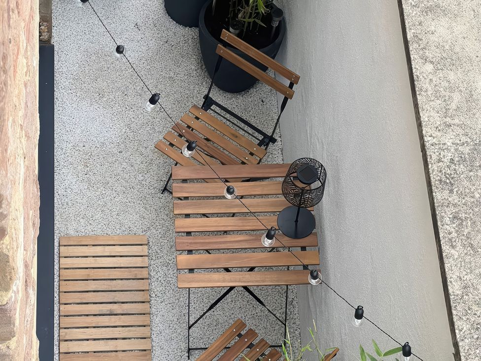 A outdoor space with a table and chairs at Craster House in Seahouses