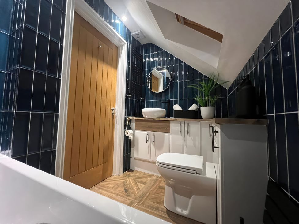 A bathroom with a sink and toilet at Craster House Seahouses