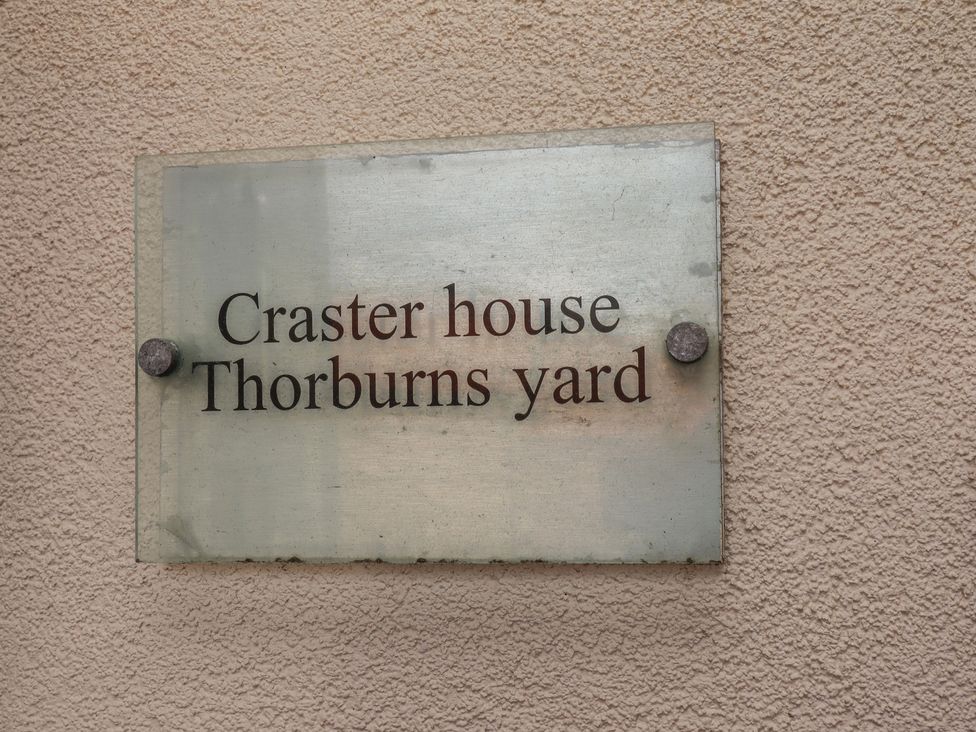 A sign for Craster House at Thorburns Yard in Seahouses