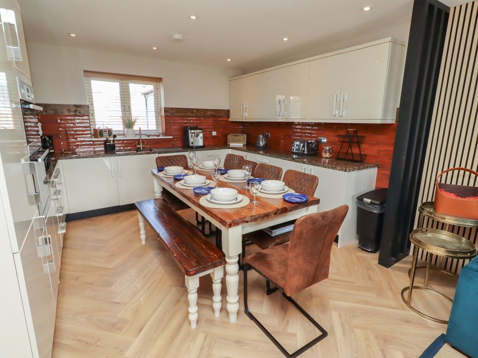 A kitchen with a dining table and chairs at Craster House in Seahouses