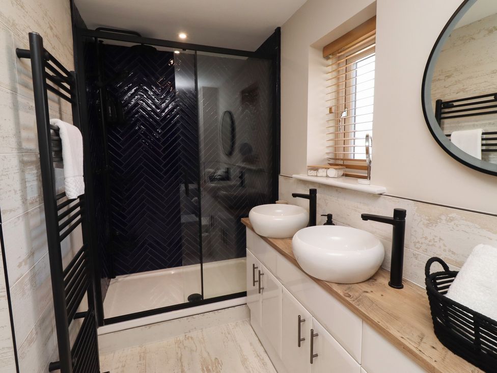 A bathroom with sinks and a shower at Craster House in Seahouses