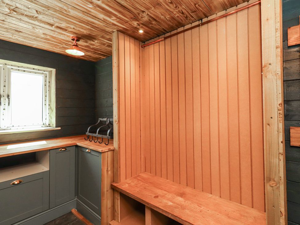 A mudroom with a bench and cabinet at Craster House Seahouses
