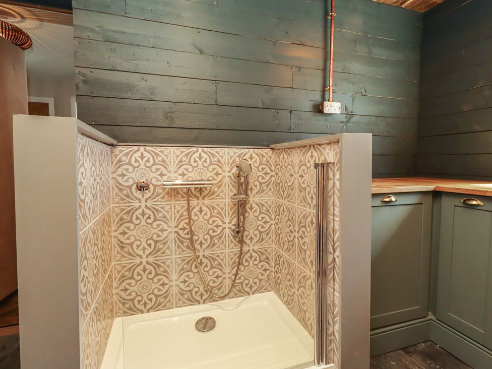 A shower area with patterned tiles at Craster House Seahouses