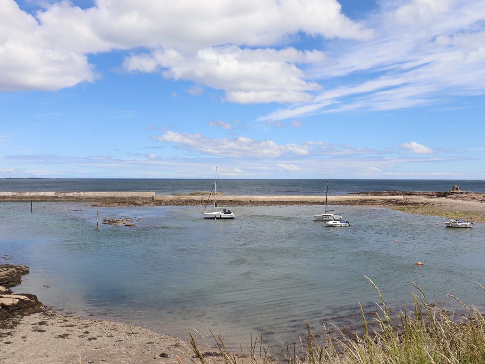 A coastal view with boats in the water at Craster House in Seahouses