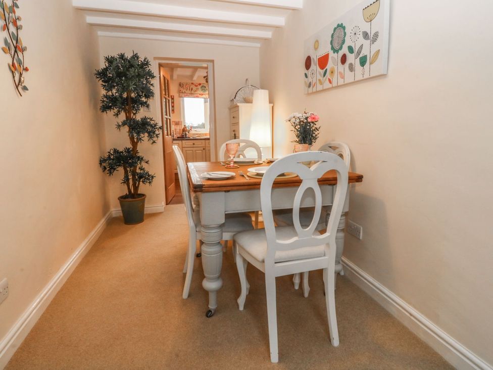 A dining area with a table and chairs at Rhianfa in Llanfairpwllgwyngyll