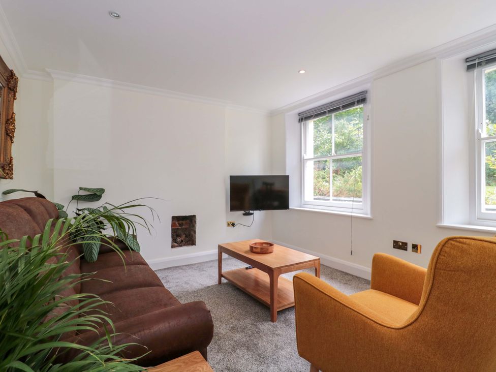 A living room with a sofa and coffee table at Flat 2 Battledown Grange in Cheltenham