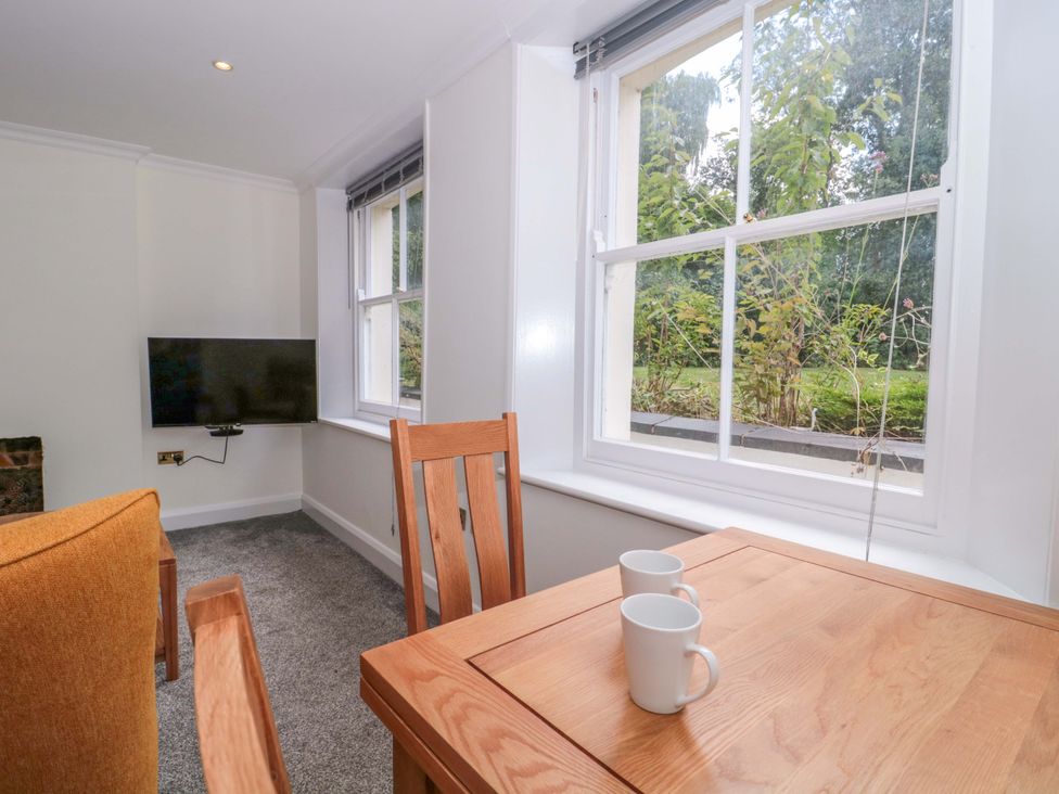 A dining room with a table and chairs at Flat 2 Battledown Grange Cheltenham
