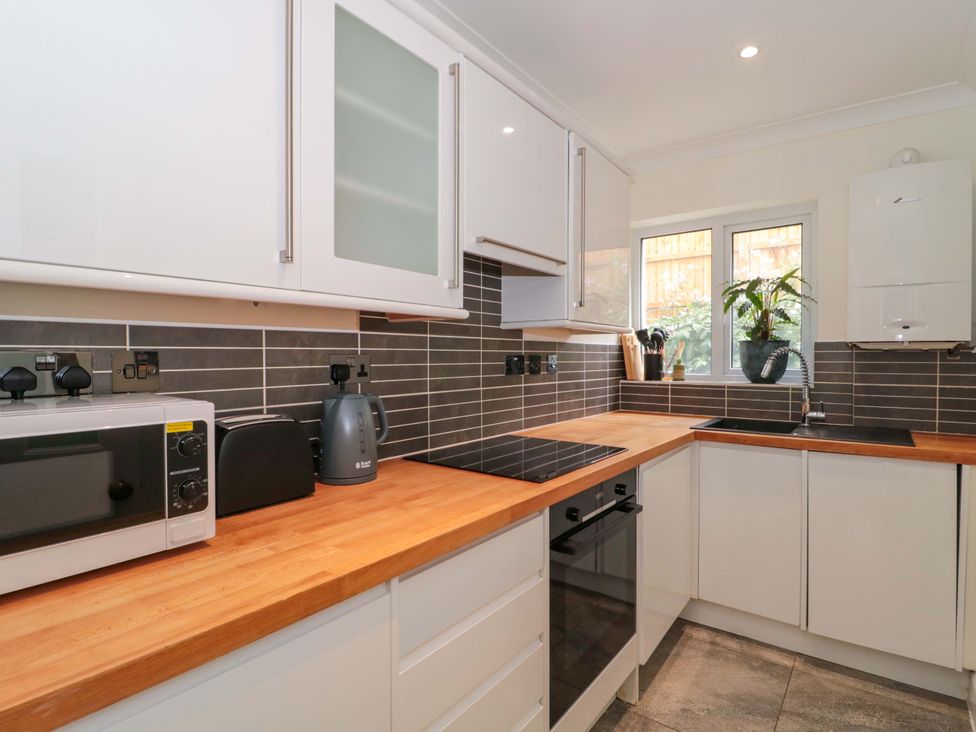 A kitchen with appliances and a sink at Flat 2 Battledown Grange Cheltenham