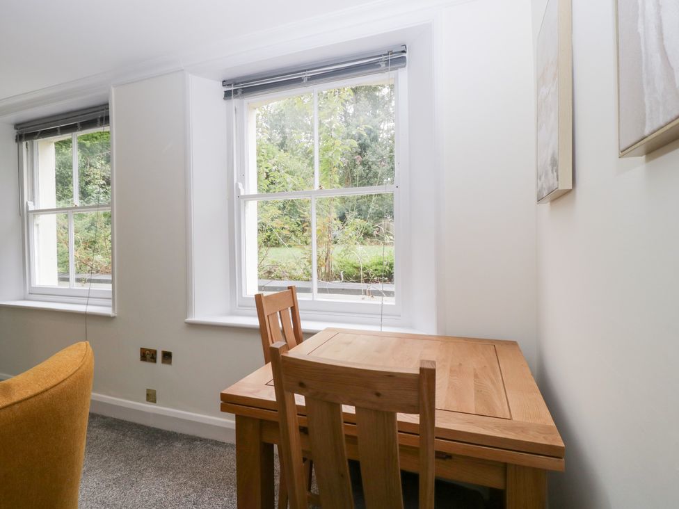A dining area with a table and chairs at Flat 2 Battledown Grange in Cheltenham