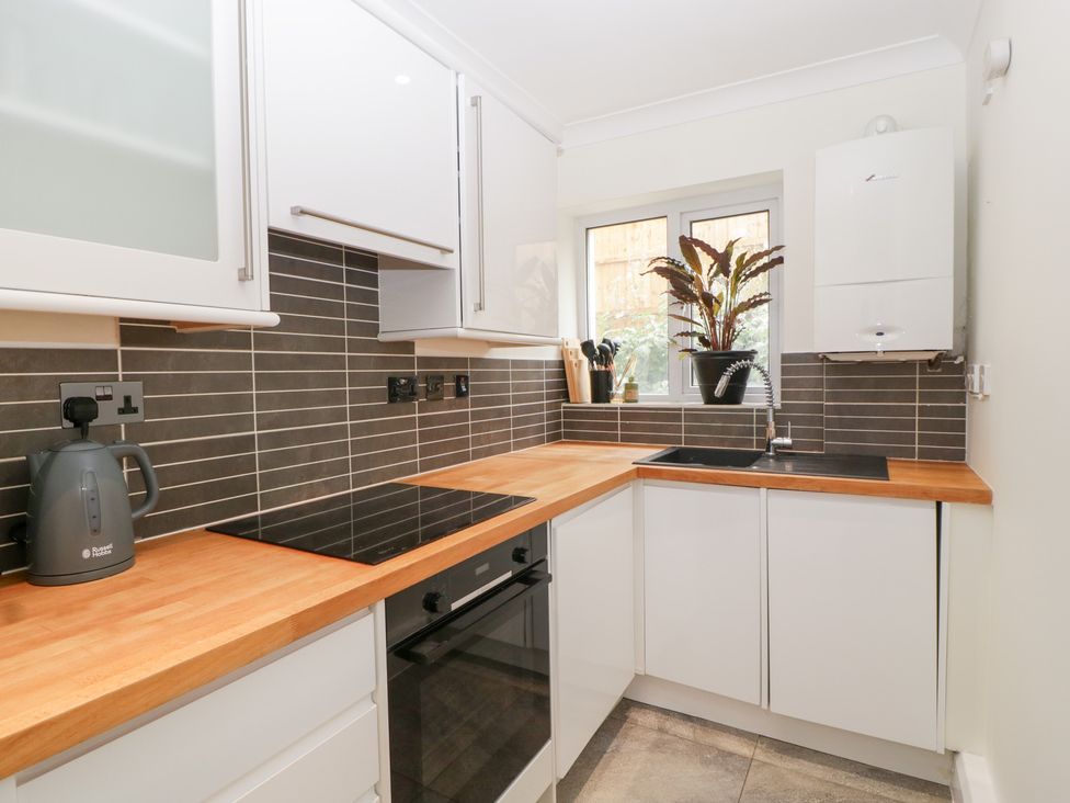 A kitchen with a countertop, sink, and oven at Flat 2 Battledown Grange, Cheltenham