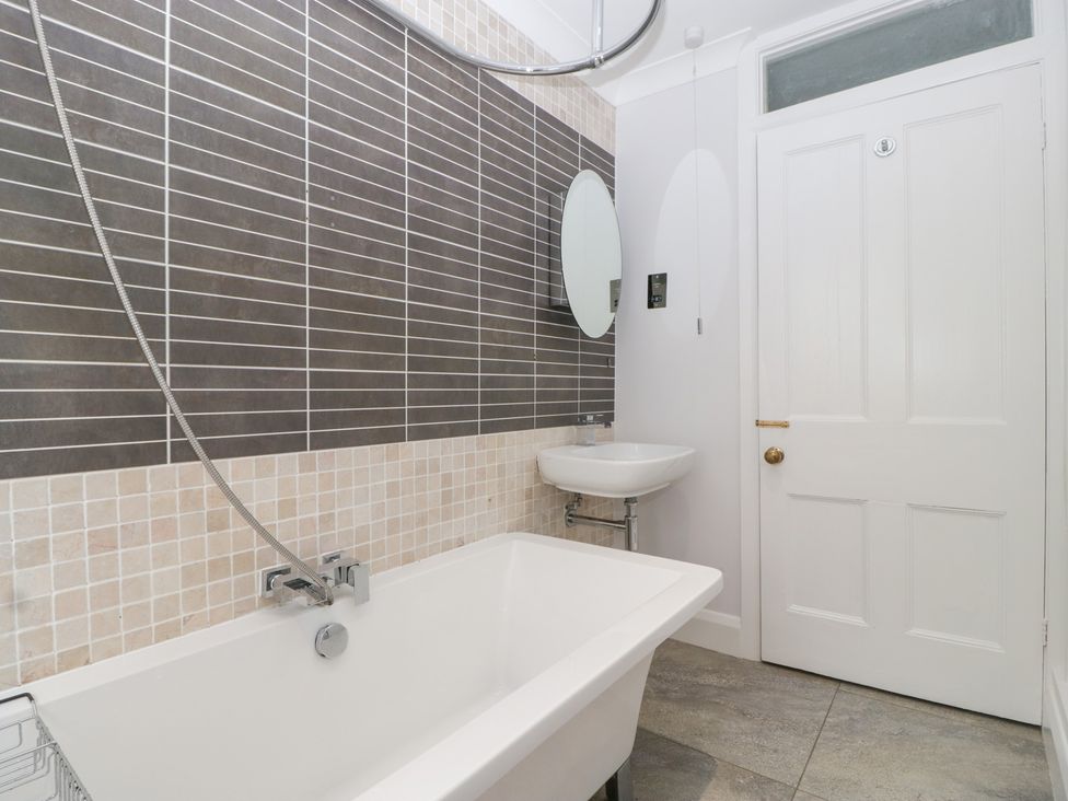A bathroom with a bathtub and sink at Flat 2 Battledown Grange in Cheltenham