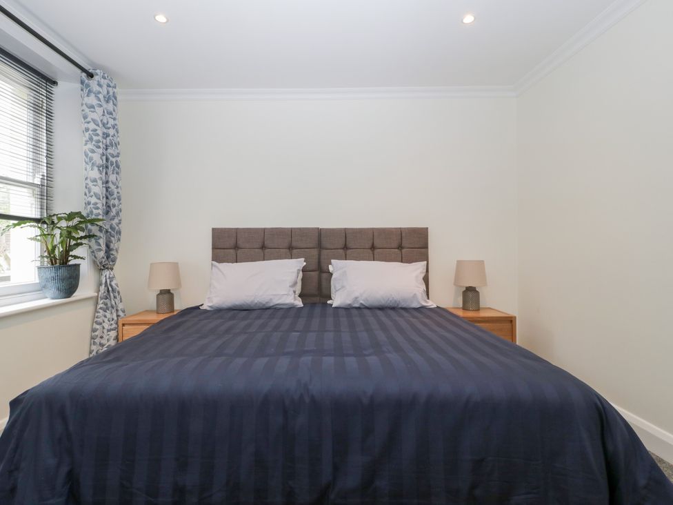 A bedroom with a bed and lamps at Flat 2 Battledown Grange, Cheltenham