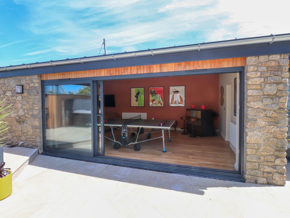 A games room with a ping pong table and artwork at Ardwyn Rhosneigr