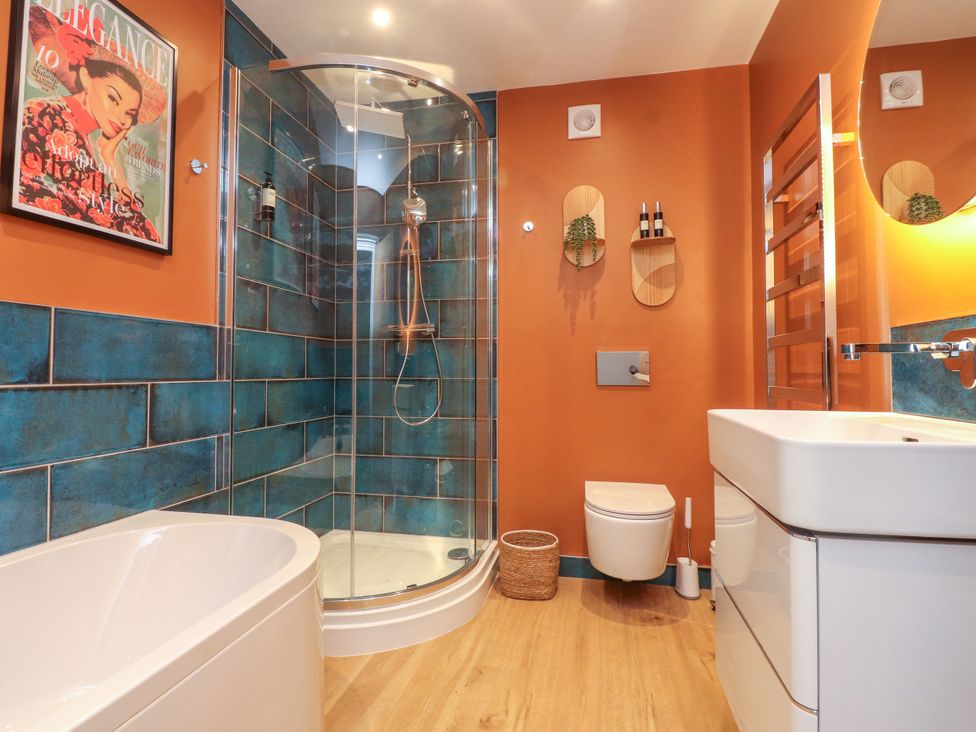 A bathroom with a shower and bathtub at Ardwyn Rhosneigr