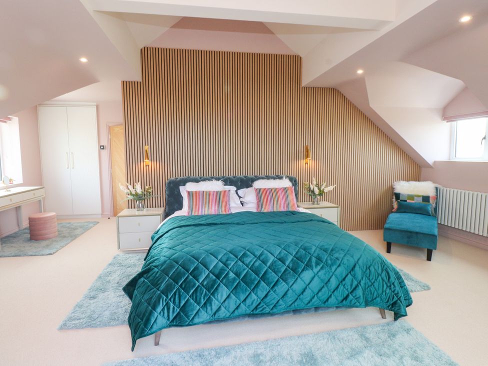 A bedroom with a bed and bedside table at Ardwyn in Rhosneigr