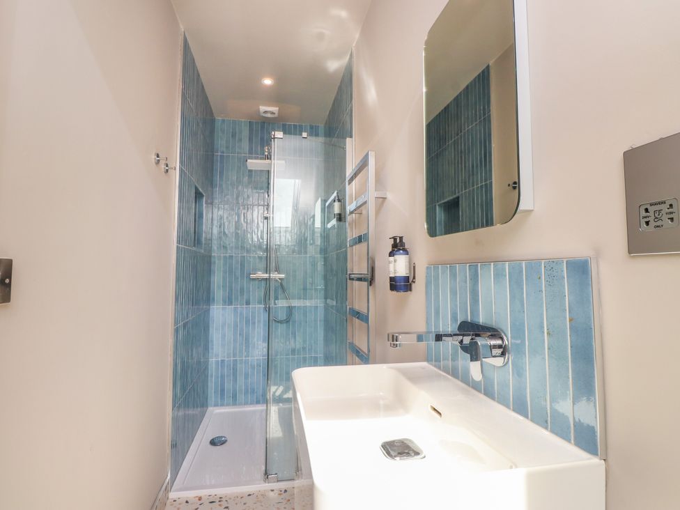 A bathroom with a shower and sink at Ardwyn Rhosneigr