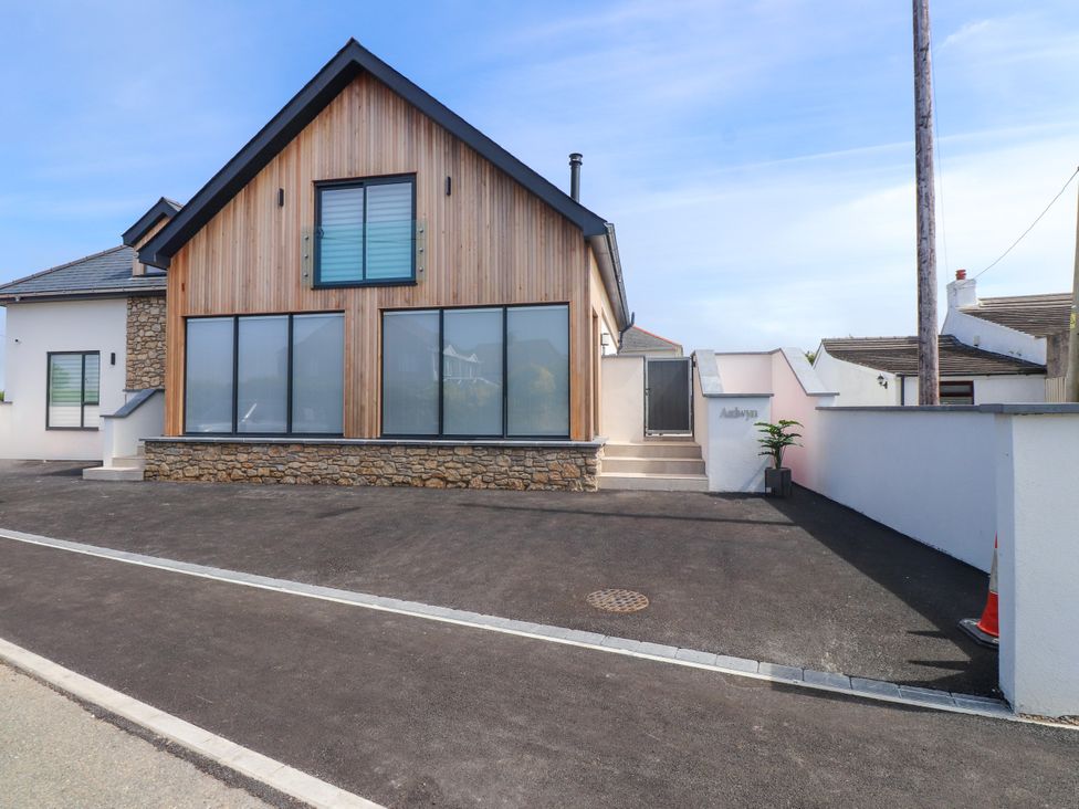 A house with multiple windows and a parking area at Ardwyn Rhosneigr