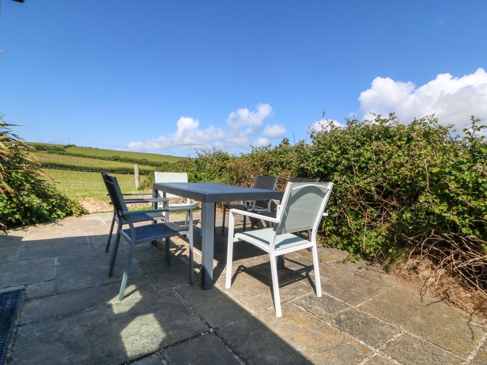 An outdoor seating area with a table and chairs at Brynffynon in Pwllheli