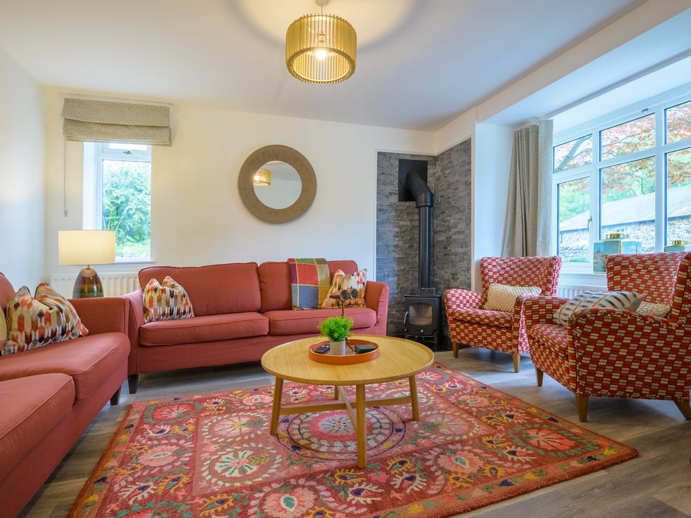 A living room with a sofa and chairs at Moss Crag in Glenridding