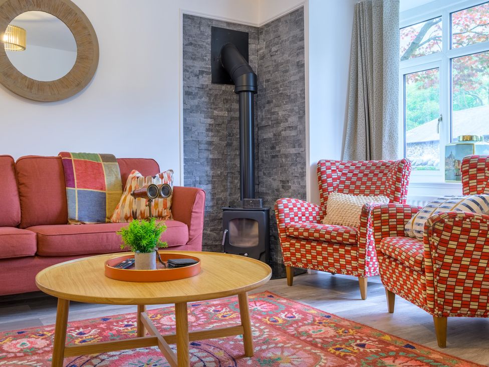 A living room with a sofa and armchairs at Moss Crag in Glenridding