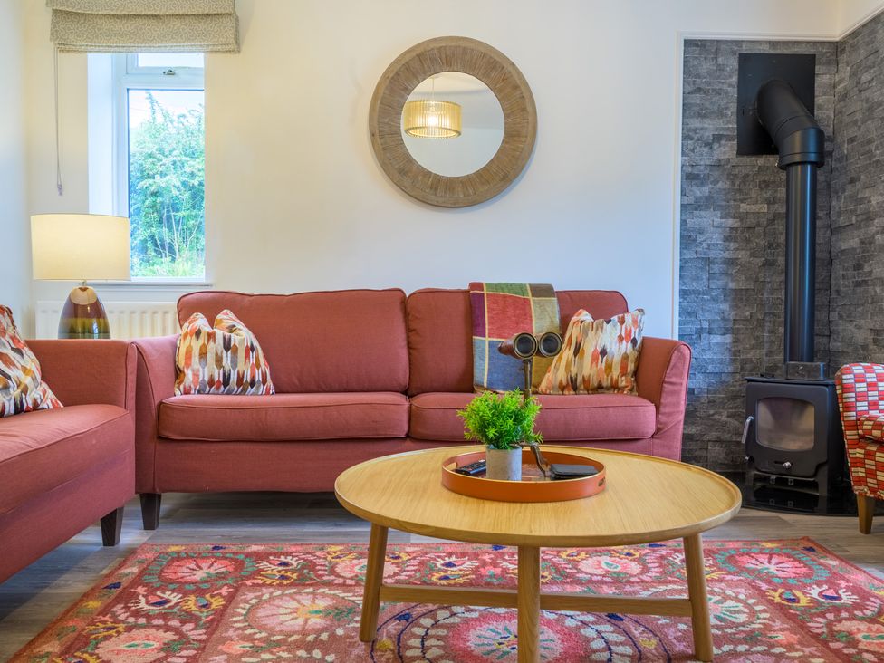 A living room with a sofa and a lamp at Moss Crag in Glenridding