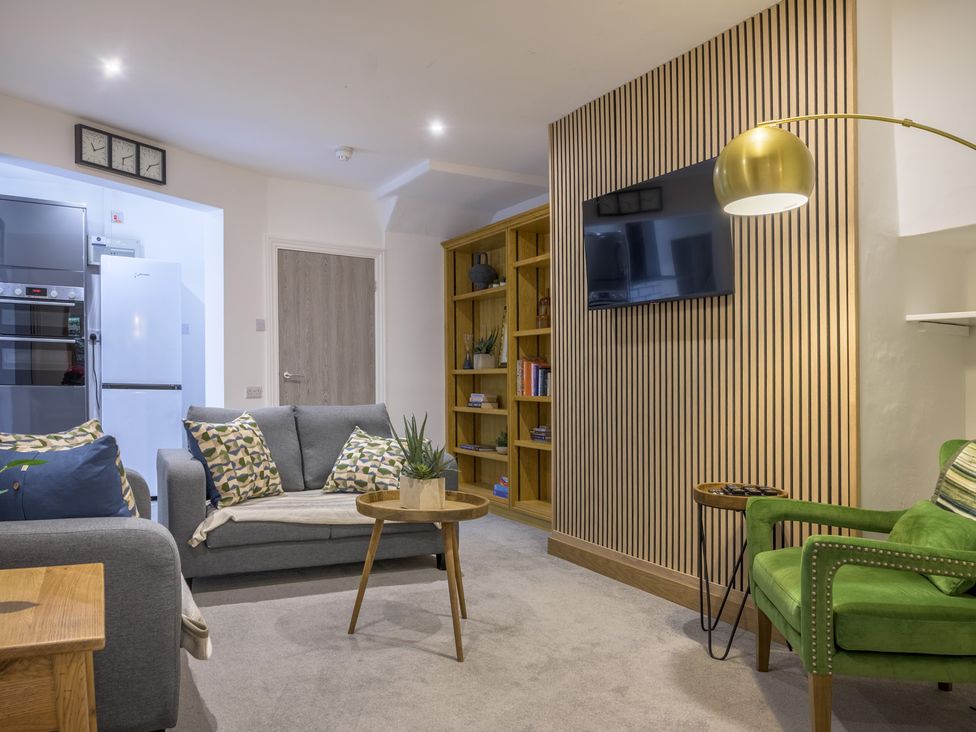 A living room with a sofa and coffee table at Moss Crag in Glenridding