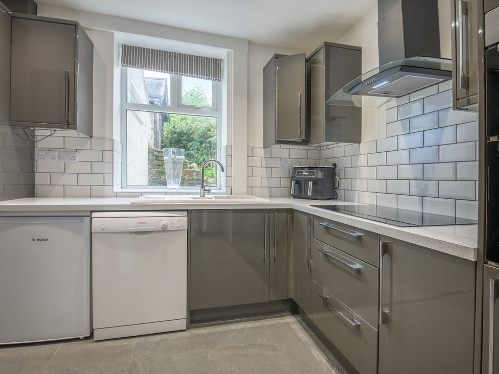 A kitchen with sink and dishwasher at Moss Crag in Glenridding