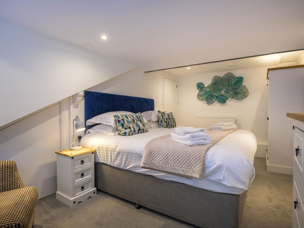 A bedroom with a bed and nightstand at Moss Crag in Glenridding