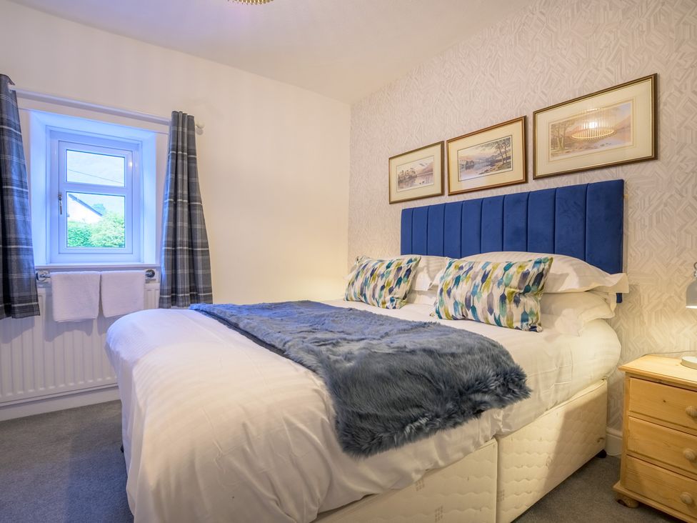 A bedroom with a bed and window at Moss Crag in Glenridding