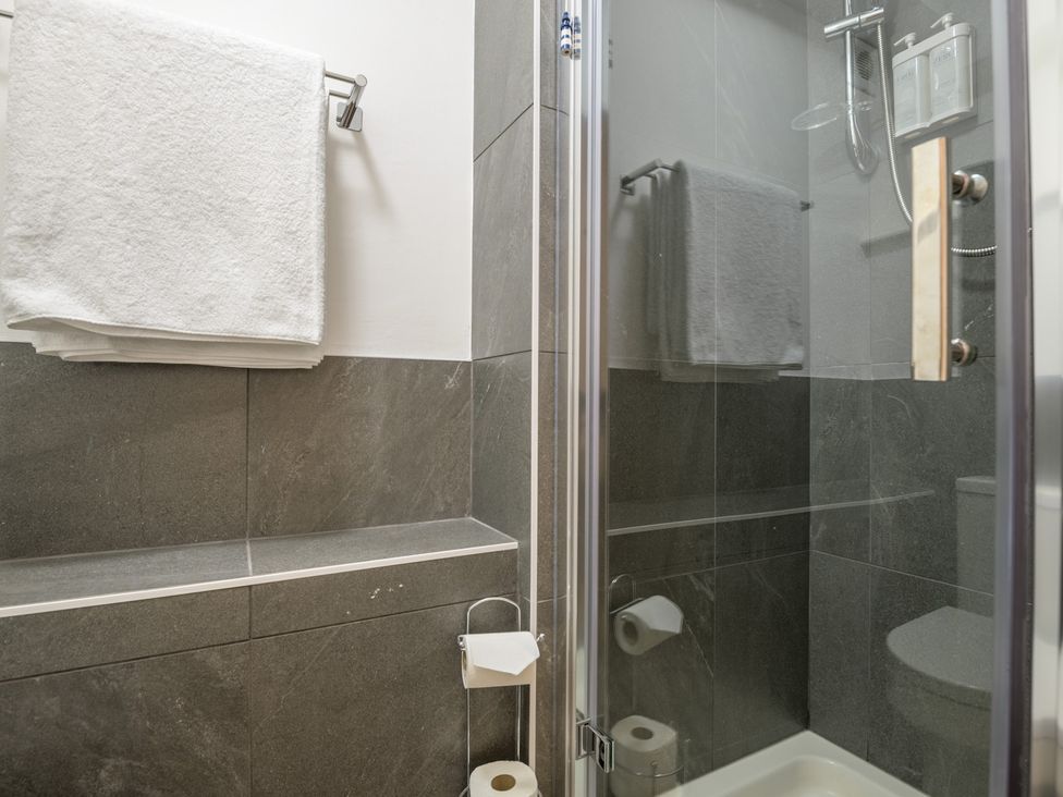 A bathroom with towels and a shower at Moss Crag in Glenridding