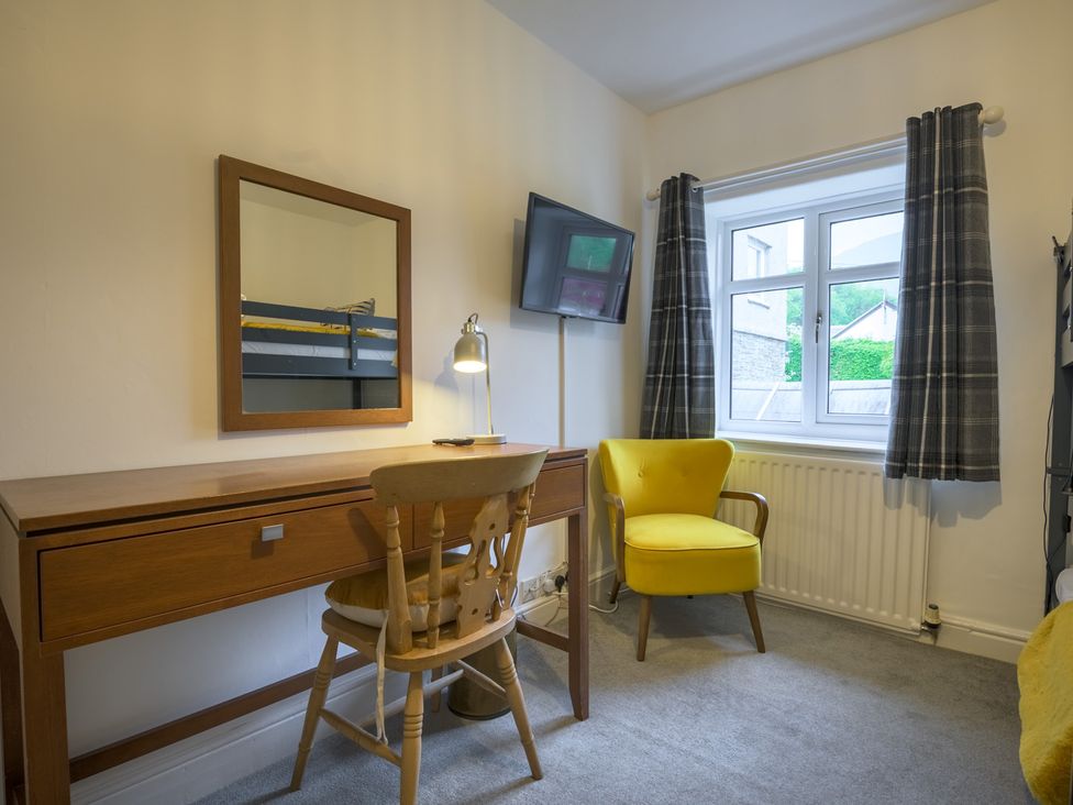A bedroom with a desk and chair at Moss Crag in Glenridding