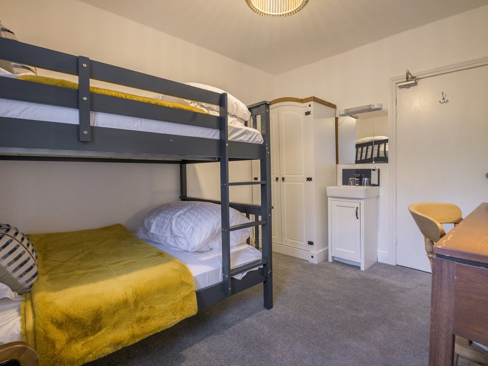 A bedroom with bunk beds and a desk at Moss Crag in Glenridding