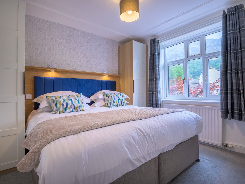A bedroom with a bed and window at Moss Crag in Glenridding