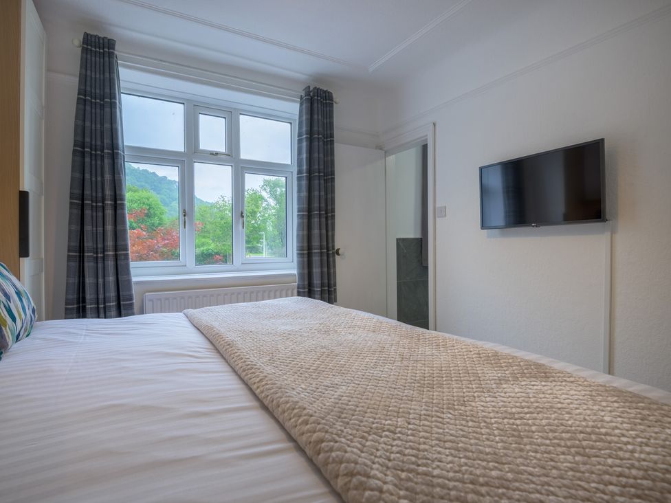 A bedroom with a bed and TV at Moss Crag in Glenridding
