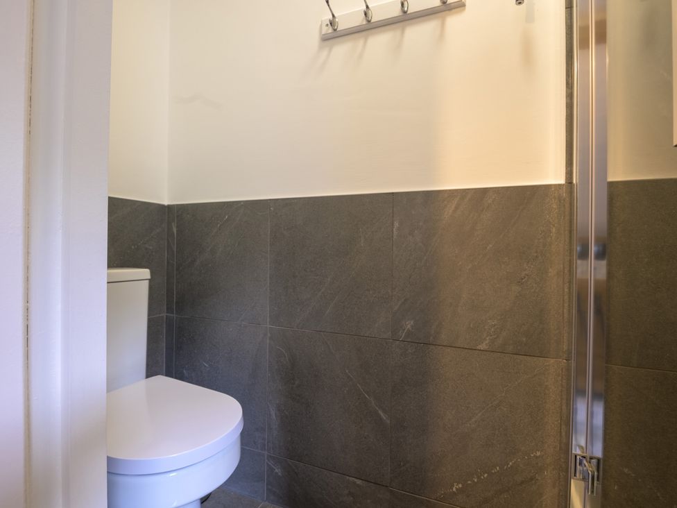 A bathroom with a toilet and a shower at Moss Crag in Glenridding