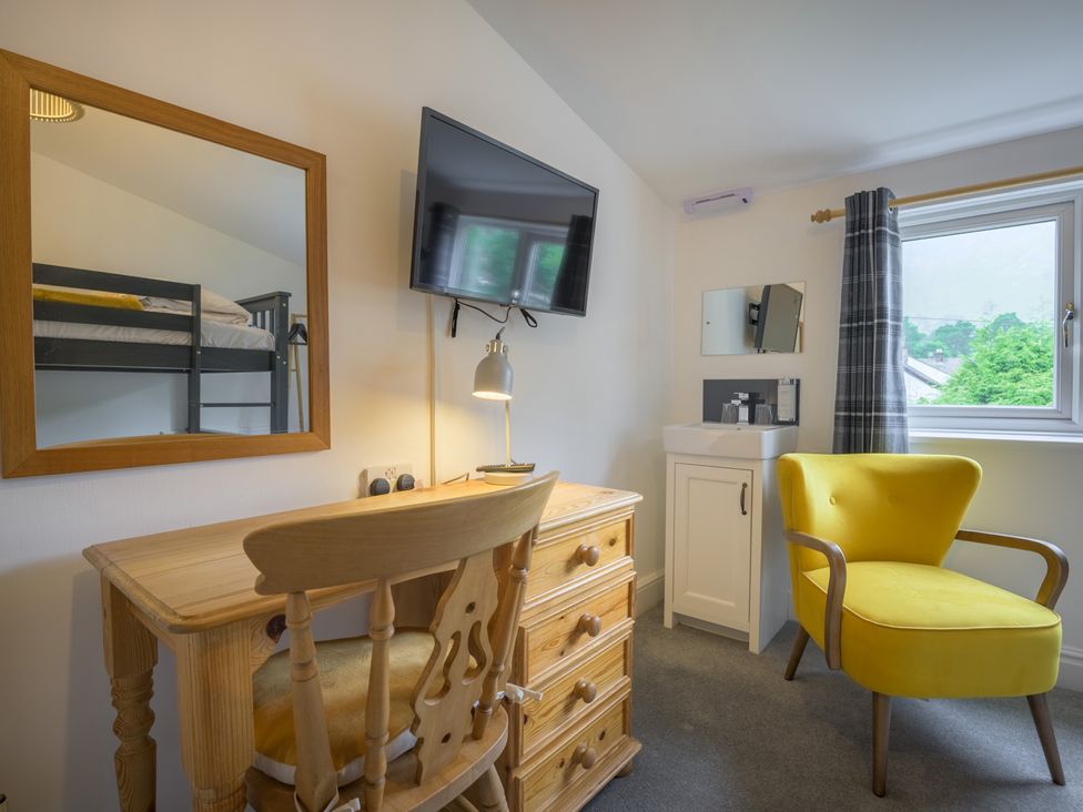 A bedroom with furniture at Moss Crag in Glenridding
