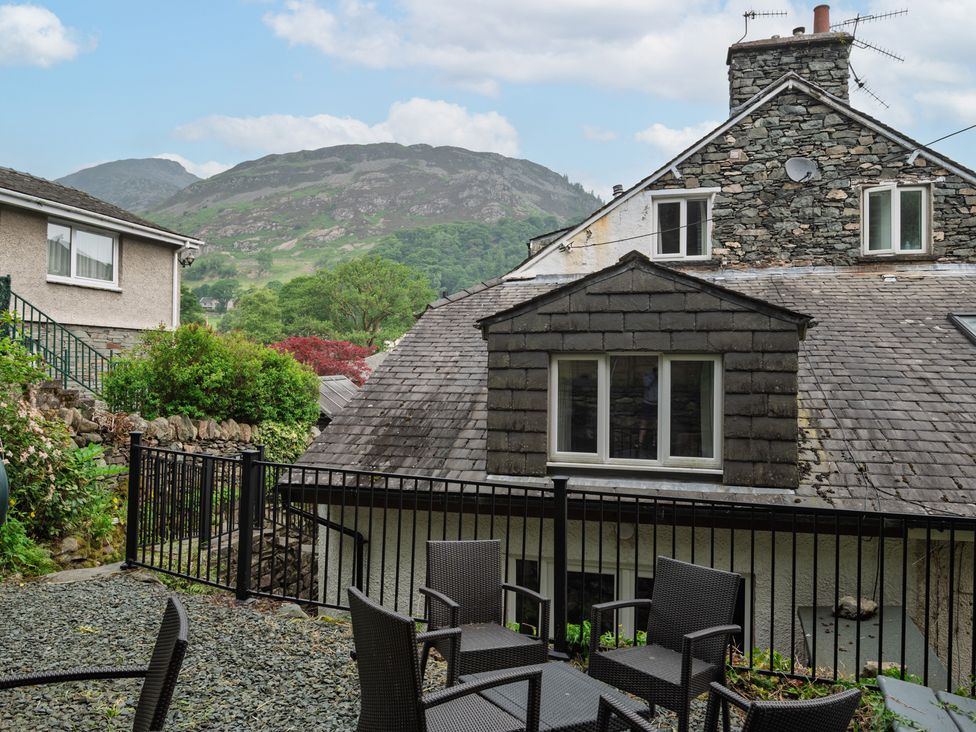 A backyard with chairs and mountain view at Moss Crag in Glenridding